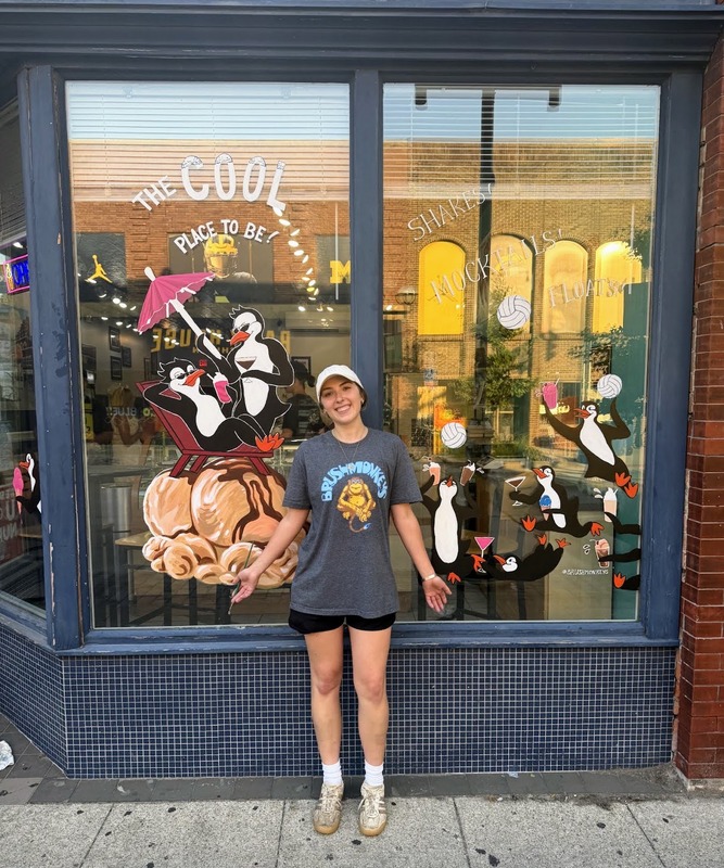 Window painting of penguins at an ice cream shop